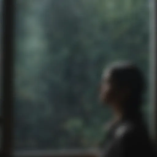 A solitary figure gazing out at a rain-soaked window, reflecting on life.